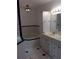 Well-lit bathroom features a soaking tub and vanity with ample storage at 23220 Rountree Ave, Port Charlotte, FL 33980