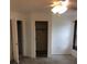 Bedroom with ceiling fan and doorway view to closet at 23220 Rountree Ave, Port Charlotte, FL 33980