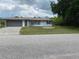 Charming single-story home featuring a well-maintained lawn and a gray two-car garage at 23220 Rountree Ave, Port Charlotte, FL 33980