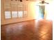 Open living room with large windows and tile floor, providing plenty of natural light and space at 23220 Rountree Ave, Port Charlotte, FL 33980