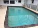 Inviting in-ground pool with cool blue water and a tile surround, perfect for summertime fun at 23220 Rountree Ave, Port Charlotte, FL 33980