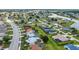 An aerial landscape showcases a neighborhood bordering a lake at 2442 Rio De Janeiro Ave, Punta Gorda, FL 33983
