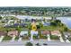 Aerial view of a beautiful property near a lake surrounded by a lush neighborhood at 2442 Rio De Janeiro Ave, Punta Gorda, FL 33983