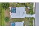Aerial view of a home displaying its roof, pool area, driveway, landscaping, and nearby streets at 2442 Rio De Janeiro Ave, Punta Gorda, FL 33983
