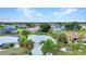 Wide aerial view showcasing the property's neighborhood, mature trees, and landscaping at 2442 Rio De Janeiro Ave, Punta Gorda, FL 33983