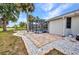 Manicured backyard with brick walkway leading to screened pool at 2442 Rio De Janeiro Ave, Punta Gorda, FL 33983