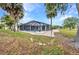 A spacious yard features an enclosed pool, patio, and gorgeous landscaping at 2442 Rio De Janeiro Ave, Punta Gorda, FL 33983
