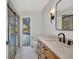 Stylish bathroom with modern vanity, sliding shower door, and pool view at 2442 Rio De Janeiro Ave, Punta Gorda, FL 33983