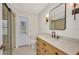 Well-lit bathroom with updated vanity, framed mirror, and glass-enclosed shower at 2442 Rio De Janeiro Ave, Punta Gorda, FL 33983