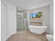 Bright bathroom featuring a modern soaking tub, glass shower, and stylish fixtures at 2442 Rio De Janeiro Ave, Punta Gorda, FL 33983
