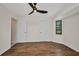 Bedroom with hardwood floors, ceiling fan, and a view of the outside at 2442 Rio De Janeiro Ave, Punta Gorda, FL 33983