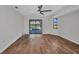 Bedroom with wood floors, ceiling fan, and sliding glass doors leading to the pool at 2442 Rio De Janeiro Ave, Punta Gorda, FL 33983