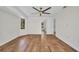 Primary bedroom with wood floors, large window, and en-suite bathroom at 2442 Rio De Janeiro Ave, Punta Gorda, FL 33983