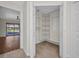 Walk-in closet with built-in shelving and drawers, adjacent to bedroom with pool view at 2442 Rio De Janeiro Ave, Punta Gorda, FL 33983