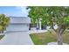 Lovely home with a well-maintained lawn, a two car garage and mature trees at 2442 Rio De Janeiro Ave, Punta Gorda, FL 33983