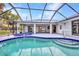 Screened-in pool with spa and view of back of home at 2442 Rio De Janeiro Ave, Punta Gorda, FL 33983