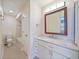 Bathroom features a vanity with marble countertop, framed mirror, and tub/shower combo at 2486 Caring Way # 14A, Port Charlotte, FL 33952