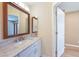 Bathroom features a vanity with marble countertop, framed mirror and modern fixtures at 2486 Caring Way # 14A, Port Charlotte, FL 33952