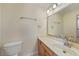 Bright bathroom with a single sink vanity and tiled mirror at 2486 Caring Way # 14A, Port Charlotte, FL 33952