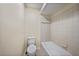 Bathroom with a standard toilet, bathtub and shower featuring tiled walls at 2486 Caring Way # 14A, Port Charlotte, FL 33952