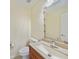 Cozy bathroom featuring wood vanity with light countertop, decorative mirror and tile flooring at 2486 Caring Way # 14A, Port Charlotte, FL 33952