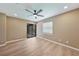 Spacious bedroom with wood-look flooring, ceiling fan and access to a screened lanai at 2486 Caring Way # 14A, Port Charlotte, FL 33952