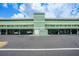 Exterior of Sunrise Towers with signage, car parking, and well-kept landscaping at 2486 Caring Way # 14A, Port Charlotte, FL 33952