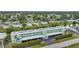 Aerial view of the Sunrise Towers complex featuring covered parking, green landscaping, and nearby canal at 2486 Caring Way # 14A, Port Charlotte, FL 33952