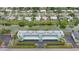 An aerial view of the Sunrise Towers complex, showcasing its green facade and water access on two sides at 2486 Caring Way # 14A, Port Charlotte, FL 33952