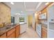 Charming kitchen features granite countertops, travertine tile backsplash, stainless sink and new appliances at 2486 Caring Way # 14A, Port Charlotte, FL 33952