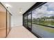 Serene screened lanai with tile flooring, ceiling fan, and views of the water at 2486 Caring Way # 14A, Port Charlotte, FL 33952