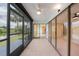 Spacious screened lanai boasts tile floors, ceiling fan, and stunning views of the lush landscaping and waterfront at 2486 Caring Way # 14A, Port Charlotte, FL 33952