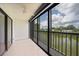 Screened lanai offers serene views of the water and surrounding lush landscape at 2486 Caring Way # 14A, Port Charlotte, FL 33952