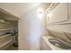 Laundry room features a stacked washer and dryer and storage space at 2486 Caring Way # 14A, Port Charlotte, FL 33952