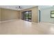Inviting living room with tile flooring, ceiling fan, and sliding glass doors to the lanai at 2486 Caring Way # 14A, Port Charlotte, FL 33952