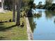 Waterfront view of canal with wildlife, trees, and landscaping at 2486 Caring Way # 14A, Port Charlotte, FL 33952