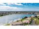 Expansive aerial view of a home by a lake in a gated community with lush landscaping at 26333 Nadir Rd # 111, Punta Gorda, FL 33983