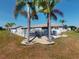 Home featuring a fenced backyard with decorative rock and lush landscaping, perfect for outdoor enjoyment at 26333 Nadir Rd # 111, Punta Gorda, FL 33983