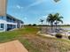 Well-maintained backyard and community pool with lake views and surrounding buildings at 26333 Nadir Rd # 111, Punta Gorda, FL 33983