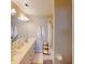 Well-lit bathroom with double sinks, a large mirror, and a shower and tub combination at 26333 Nadir Rd # 111, Punta Gorda, FL 33983