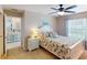 Cozy bedroom featuring a ceiling fan, a comfortable bed, and view to the kitchen at 26333 Nadir Rd # 111, Punta Gorda, FL 33983