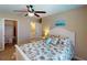 Charming bedroom featuring closet and bathroom access, a ceiling fan, and a comfortable bed at 26333 Nadir Rd # 111, Punta Gorda, FL 33983