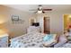 Well-lit bedroom featuring a ceiling fan, a comfortable bed, dresser, and closet access at 26333 Nadir Rd # 111, Punta Gorda, FL 33983