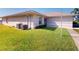 Well maintained home exterior, landscaped lawn, and external air conditioning unit at 26333 Nadir Rd # 111, Punta Gorda, FL 33983