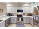 Well-equipped kitchen featuring stainless steel appliances, white cabinets, and a functional layout at 26333 Nadir Rd # 111, Punta Gorda, FL 33983