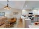 Open-concept layout with dining area flowing into a modern kitchen featuring white cabinetry at 26333 Nadir Rd # 111, Punta Gorda, FL 33983