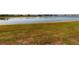 Scenic view of the lake and its surroundings from a grassy bank at 26333 Nadir Rd # 111, Punta Gorda, FL 33983