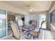 Covered lanai with dining furniture, ceiling fan, and view into the home's interior at 26333 Nadir Rd # 111, Punta Gorda, FL 33983