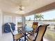 A lanai with dining set, grill, and views of the pool and lake at 26333 Nadir Rd # 111, Punta Gorda, FL 33983