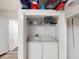 Convenient laundry closet featuring a washer, dryer, and built-in shelving for organized storage at 26333 Nadir Rd # 111, Punta Gorda, FL 33983